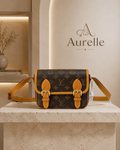 Monogram saddle crossbody on travertine plinth
